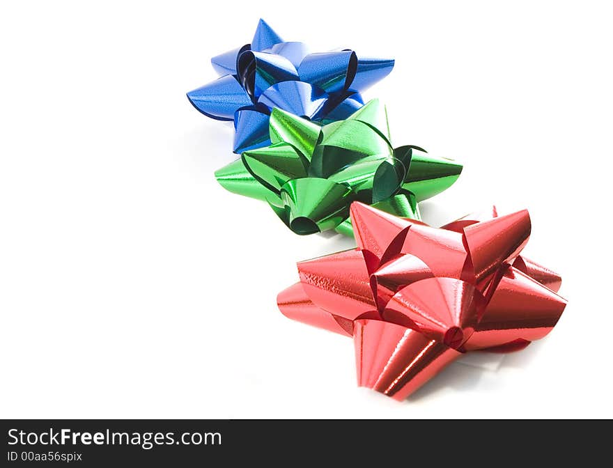 Red green and blue christmas bows over white. Red green and blue christmas bows over white