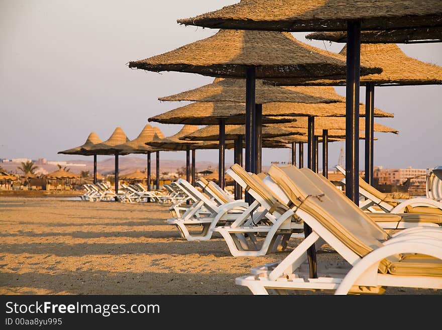 Sunbeds and parasols on the beach in the morning