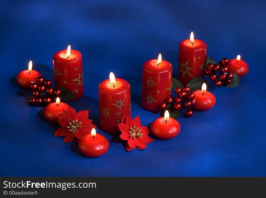 Red candles assorted on a blue background