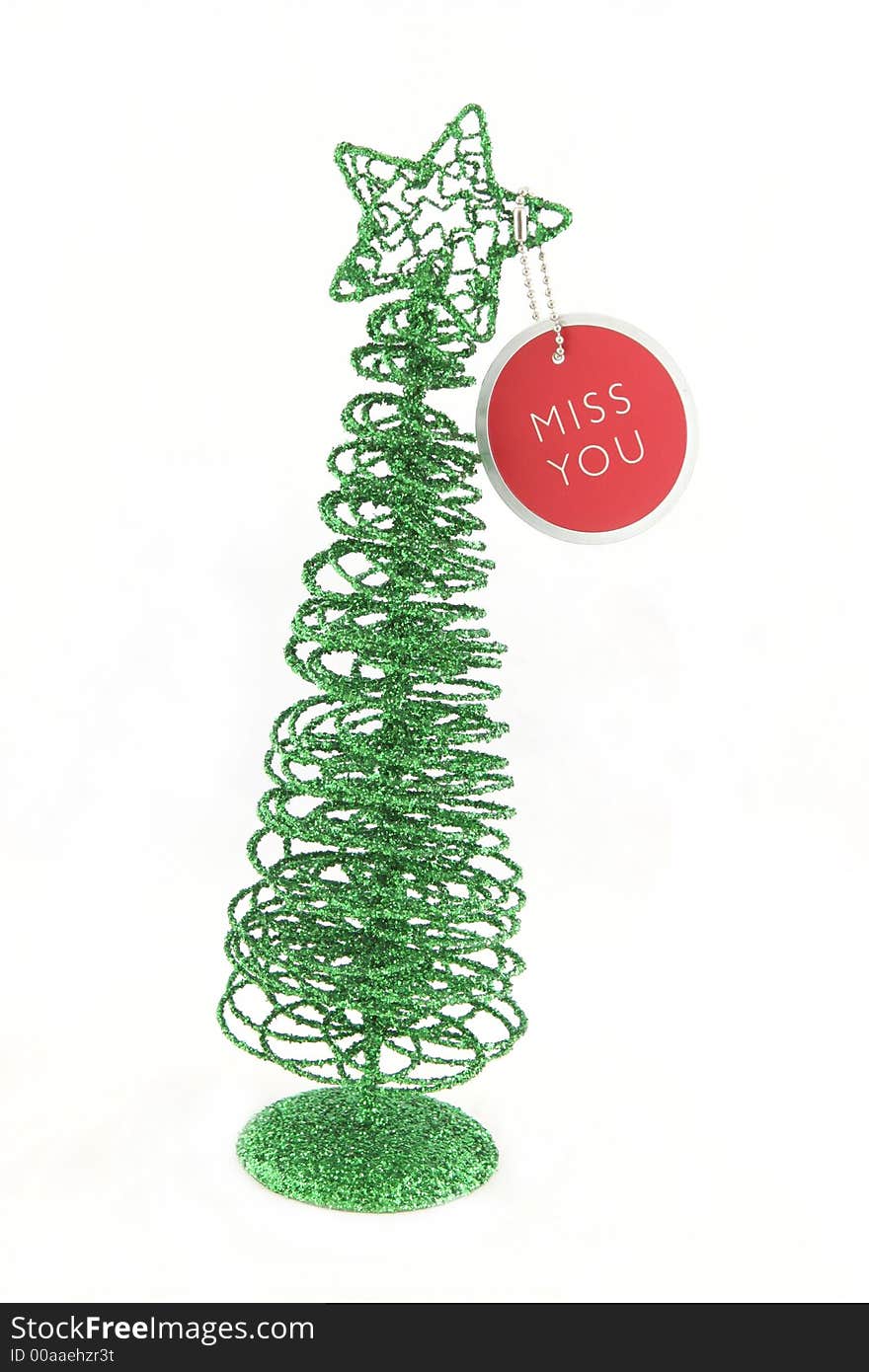 Green Christmas tree with a miss you tag - isolated. Green Christmas tree with a miss you tag - isolated