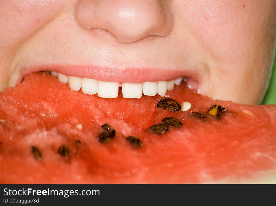 A girl eating red whatermelon