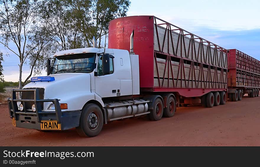 A tractor trailer parked on the road.