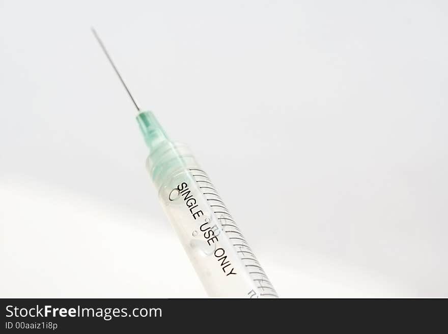 Diposable syringe over white background