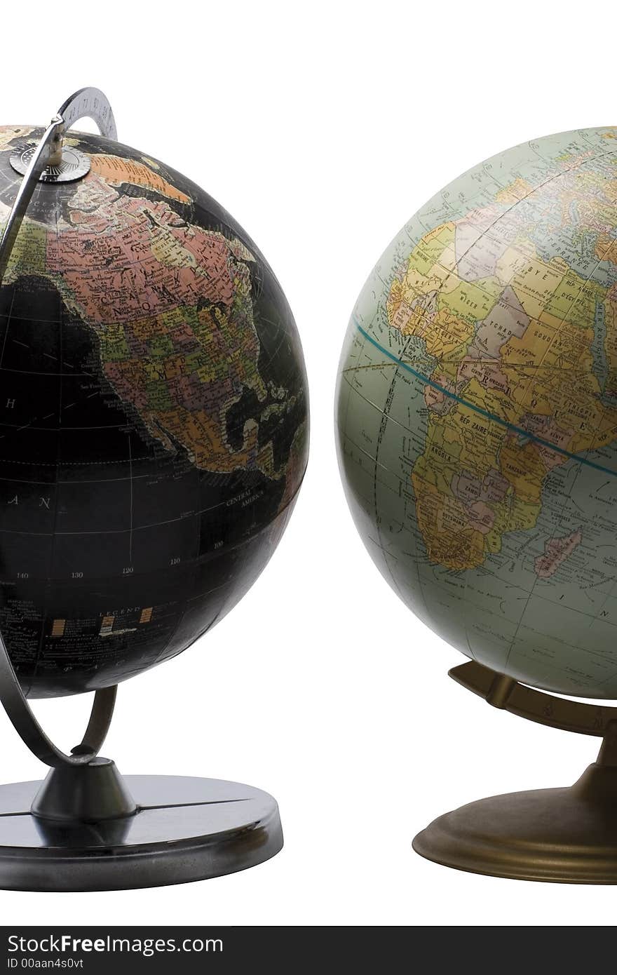 Terrestrial globe in black color showing the american continent facing a blue globe showing the african continent. Terrestrial globe in black color showing the american continent facing a blue globe showing the african continent