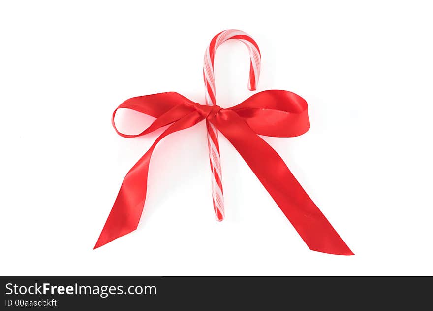 A candy cane tied up with a red bow. A candy cane tied up with a red bow.