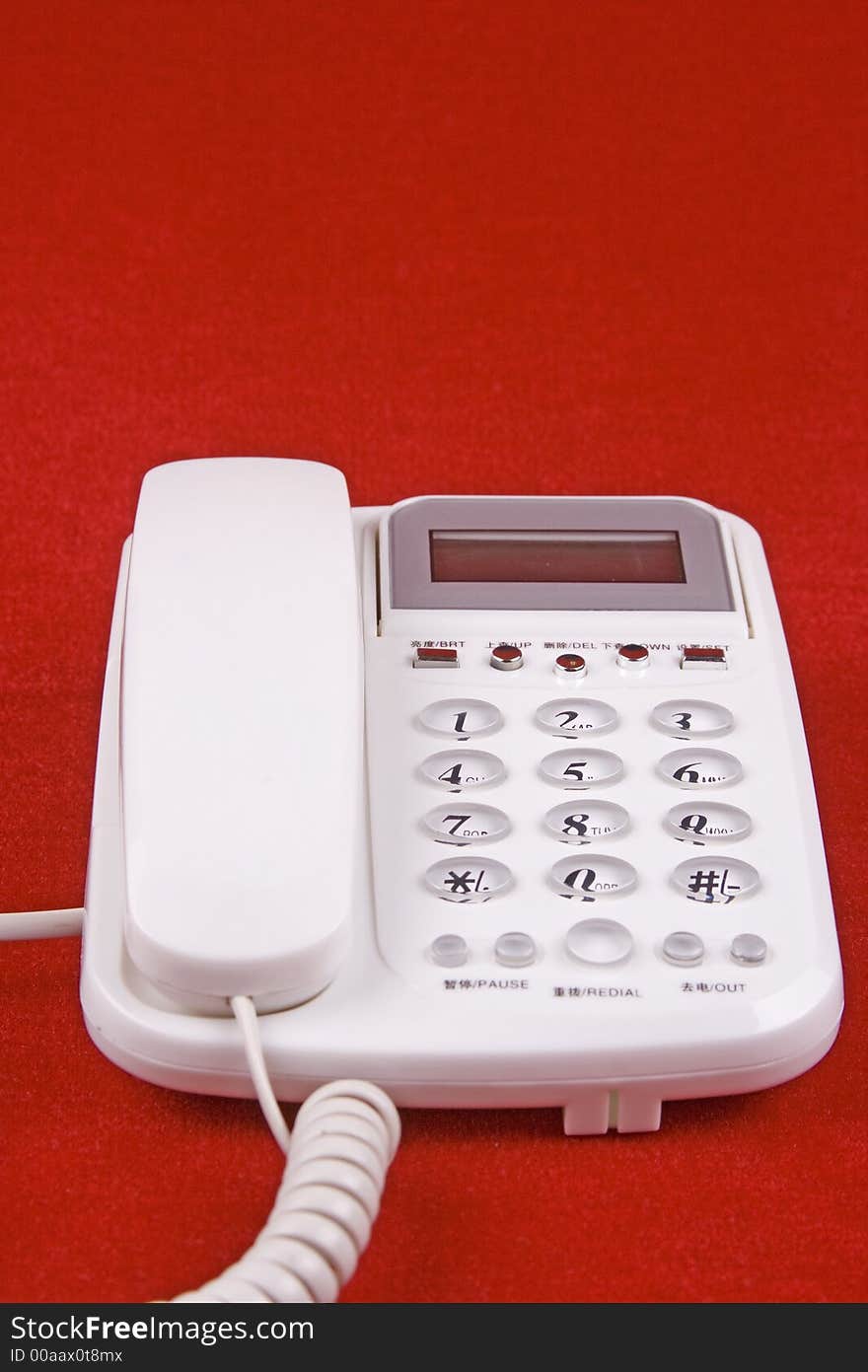 An analog telephone display in red background.