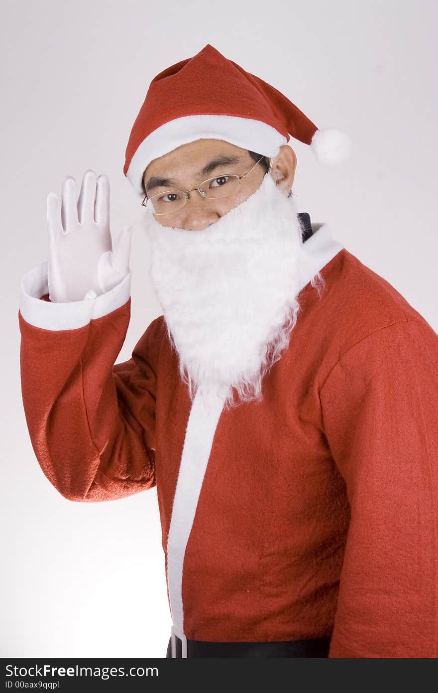 Asian Santa Claus showing greetings toward camera. Asian Santa Claus showing greetings toward camera.