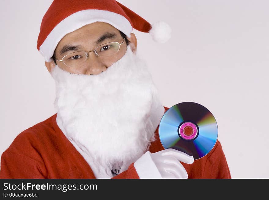 Asian Santa Claus holding a compact disc. Asian Santa Claus holding a compact disc.