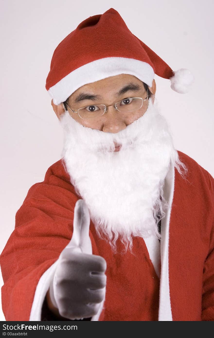 Asian Santa showing a thumbs up gesture. Asian Santa showing a thumbs up gesture.