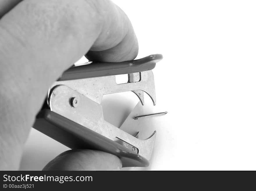 Man's hand using a staple remover