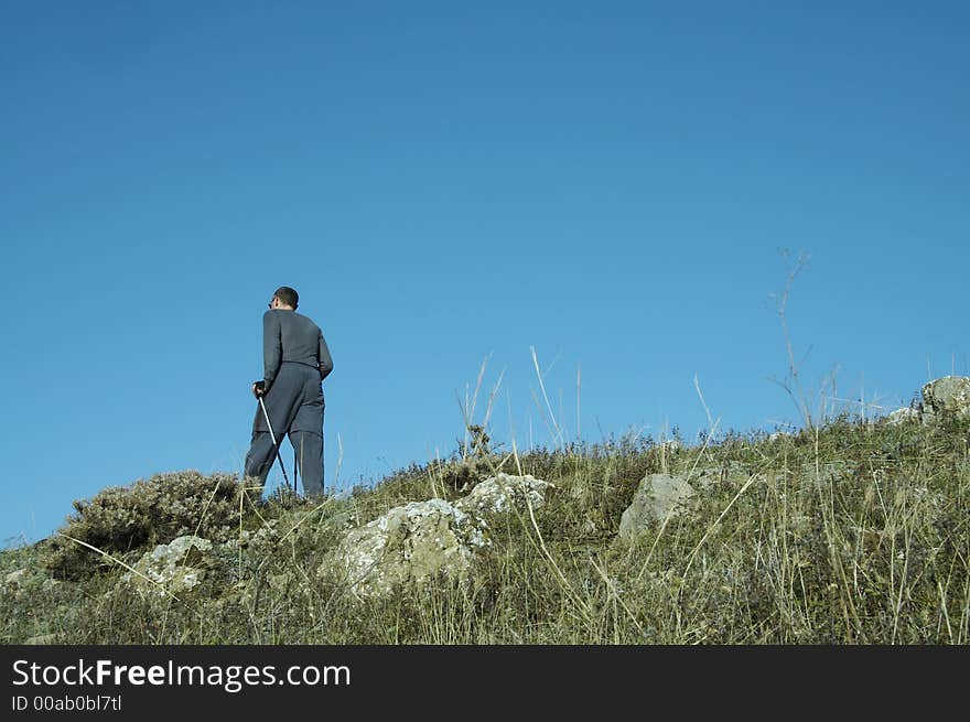 Men going up on the green hill. Men going up on the green hill