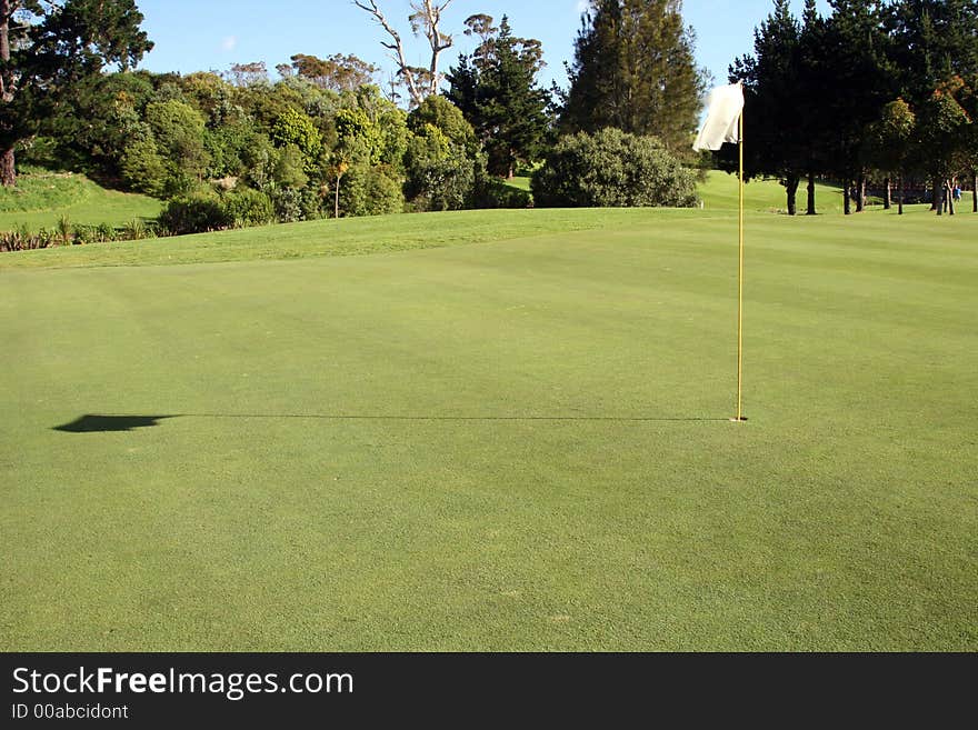 Flag and shadow on the green