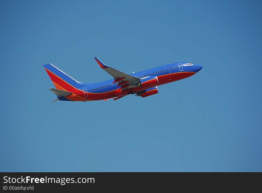 Modern passenger jetliner taking off against blue sky. Modern passenger jetliner taking off against blue sky