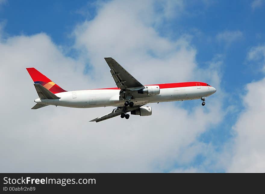 Heavy jetliner taking off against blue sky. Heavy jetliner taking off against blue sky