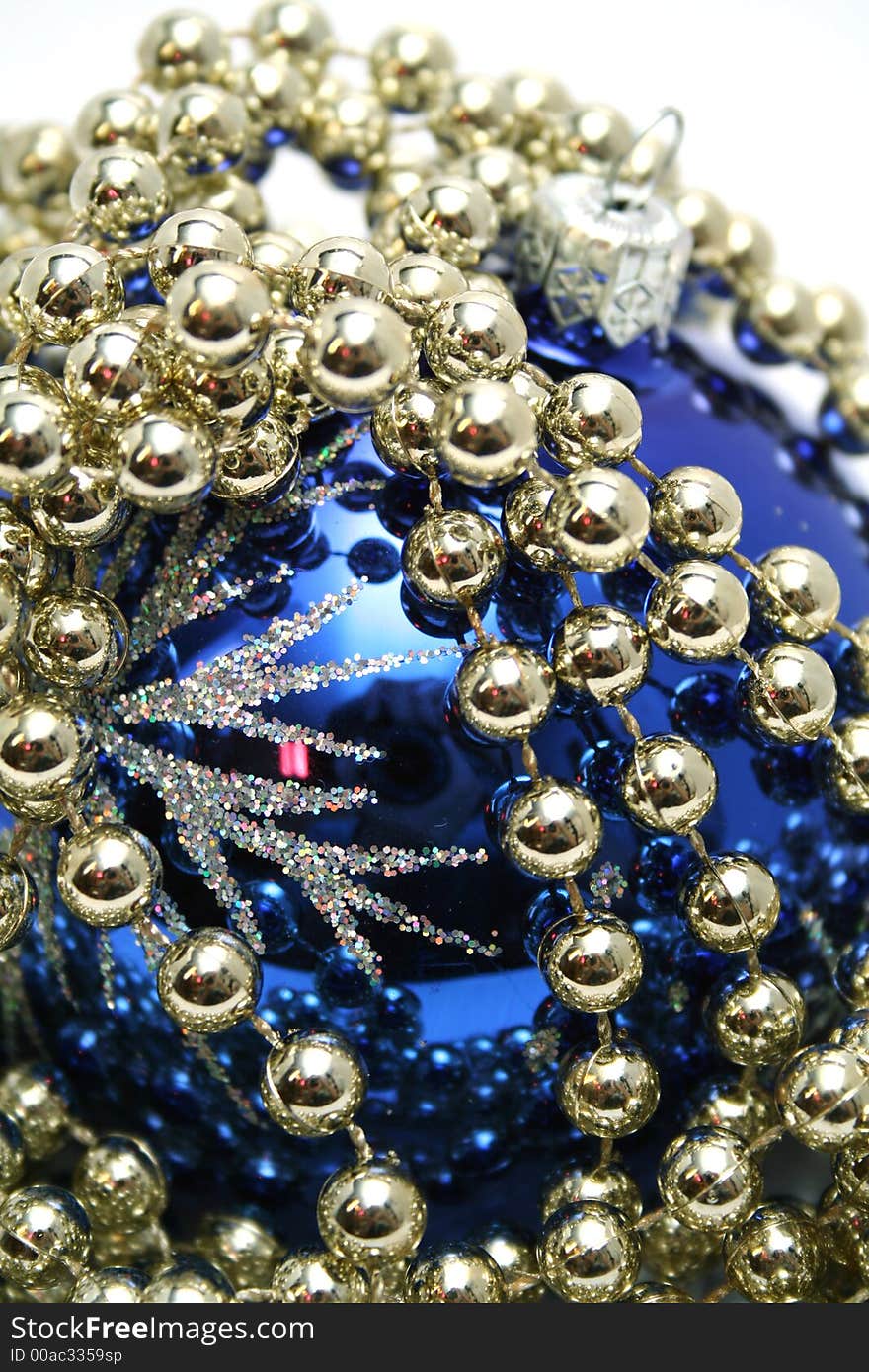 Blue glass sphere and celebratory beads on a white background