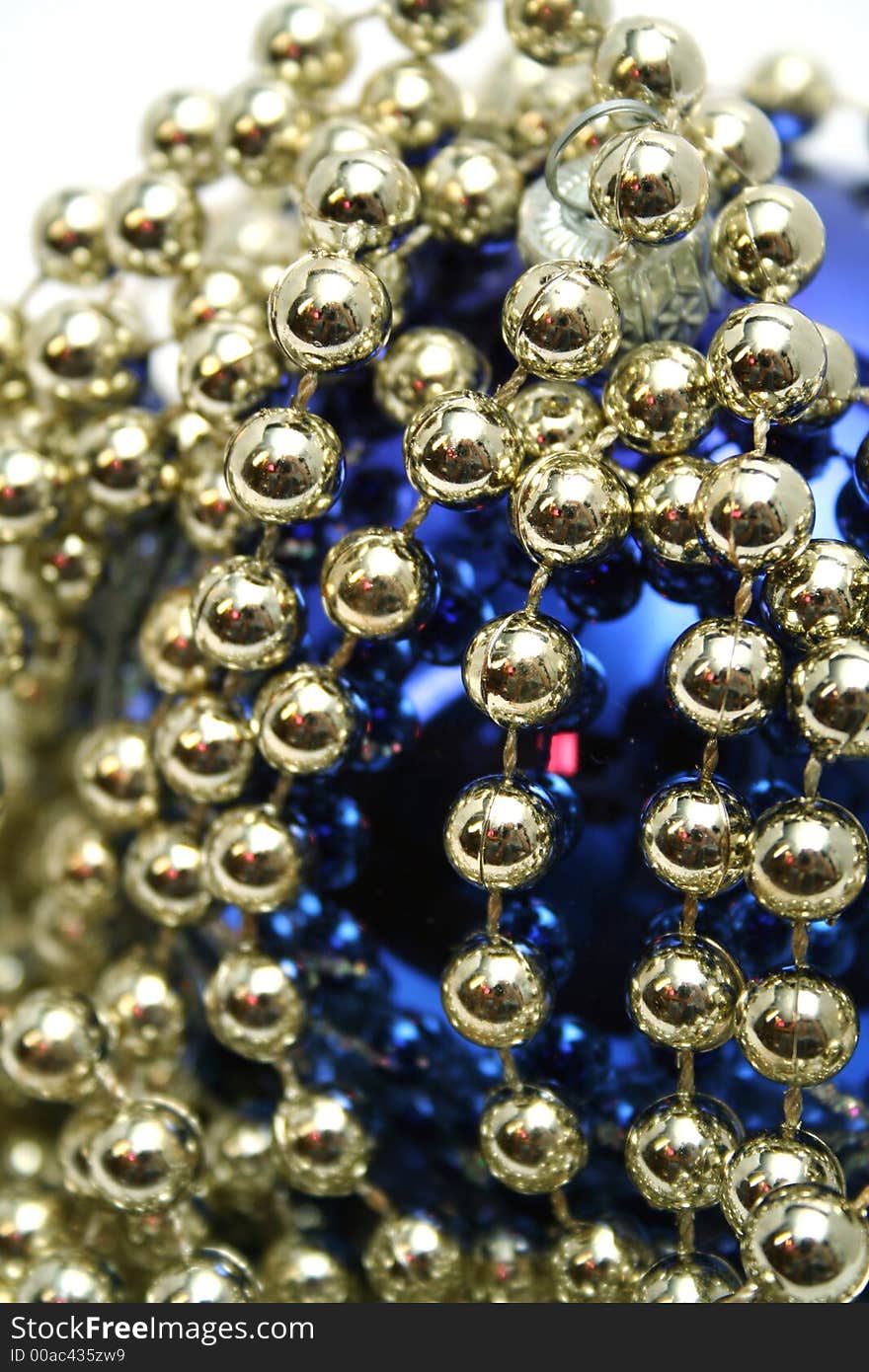 Dark blue glass sphere with a pattern and a celebratory beads of golden color