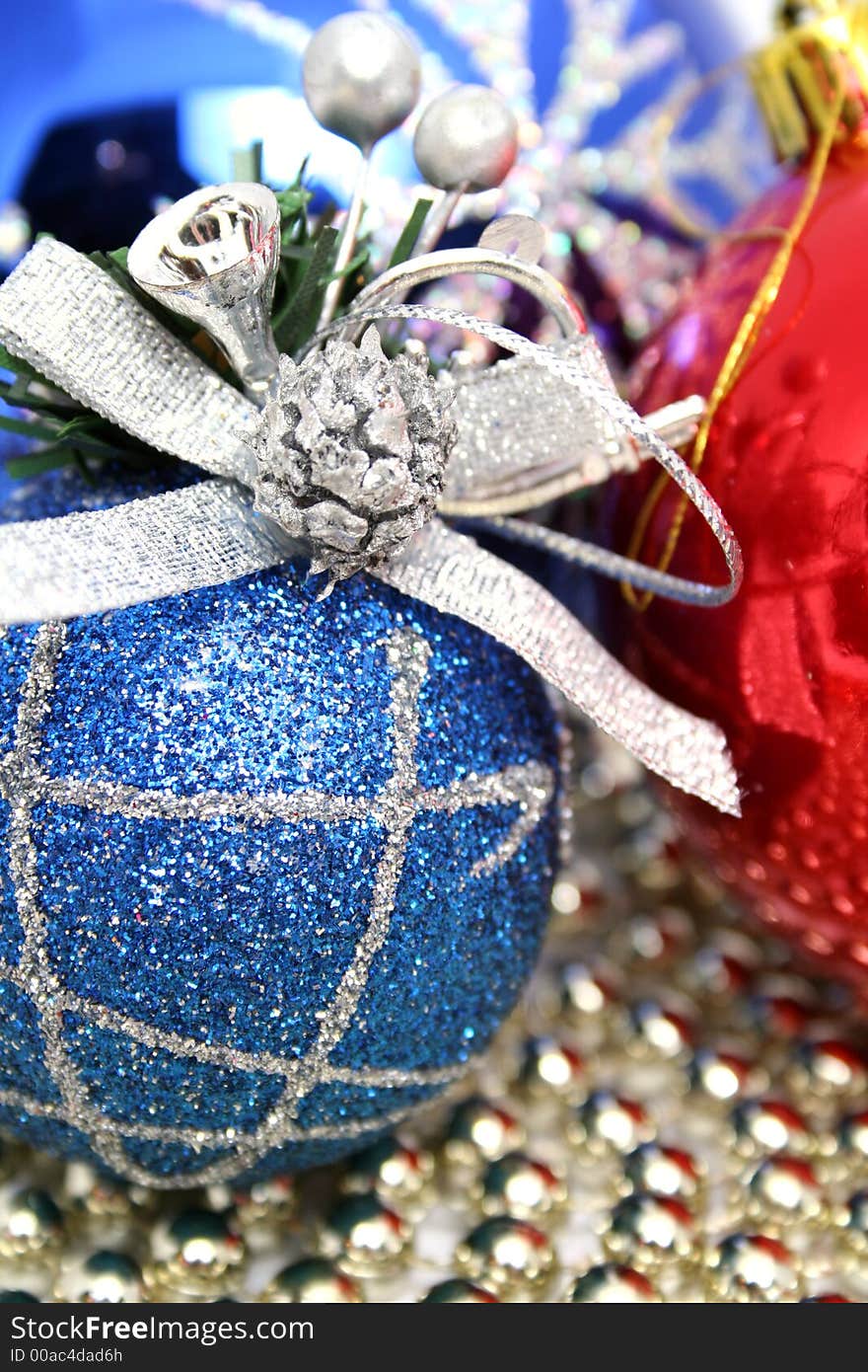 Christmas spheres of various color with a pattern on a background of a multi-coloured beads