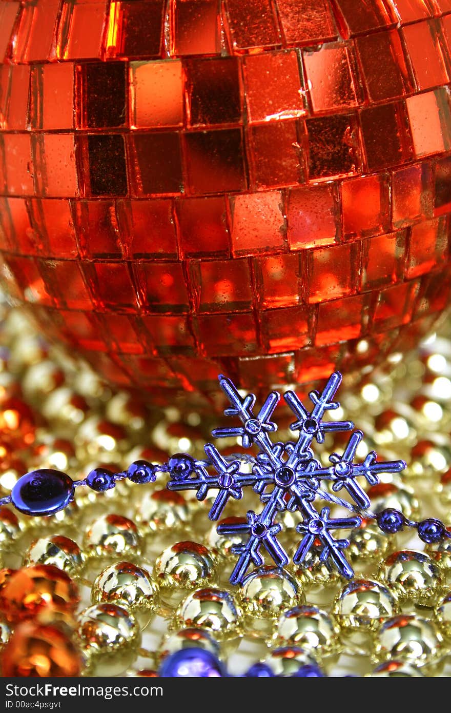 Mirror celebratory sphere of red color and snowflake of dark blue color. Mirror celebratory sphere of red color and snowflake of dark blue color