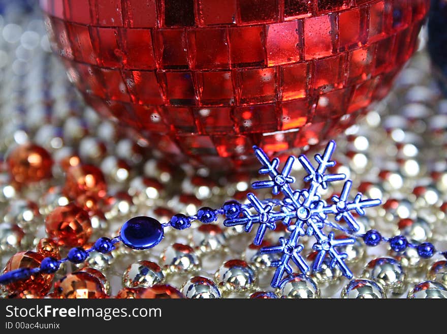 Mirror New Year's sphere of red color and snowflake of dark blue color. Mirror New Year's sphere of red color and snowflake of dark blue color