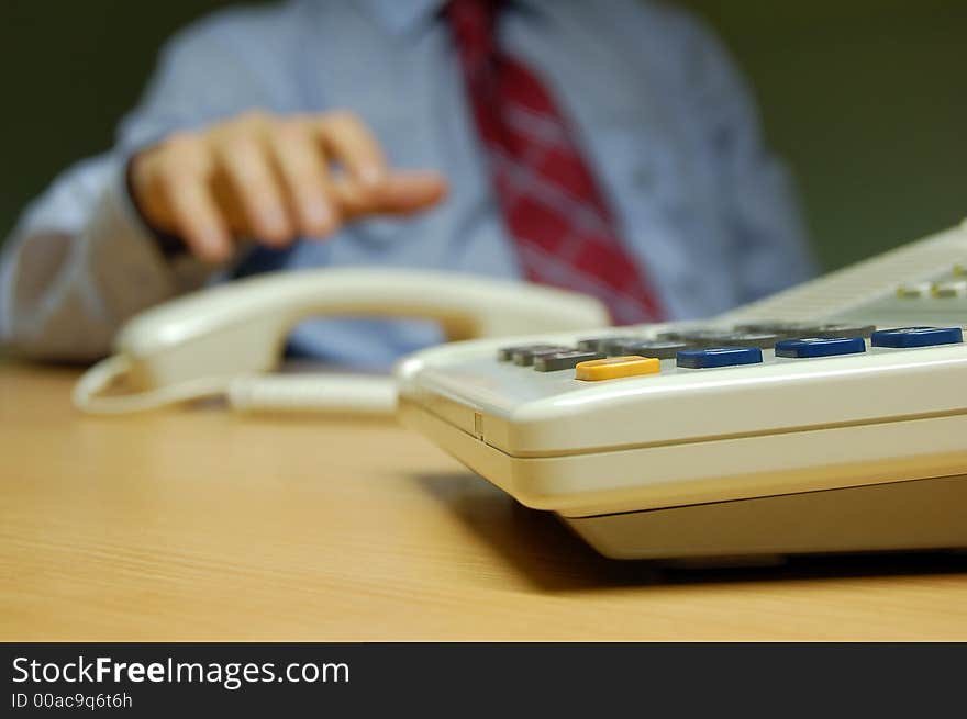 A businessman about to talk on the phone. A businessman about to talk on the phone.