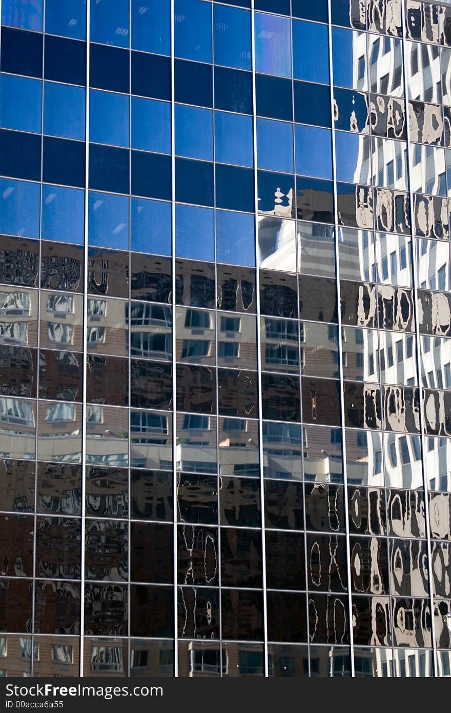 Blue sky reflected in a glass office building. Blue sky reflected in a glass office building