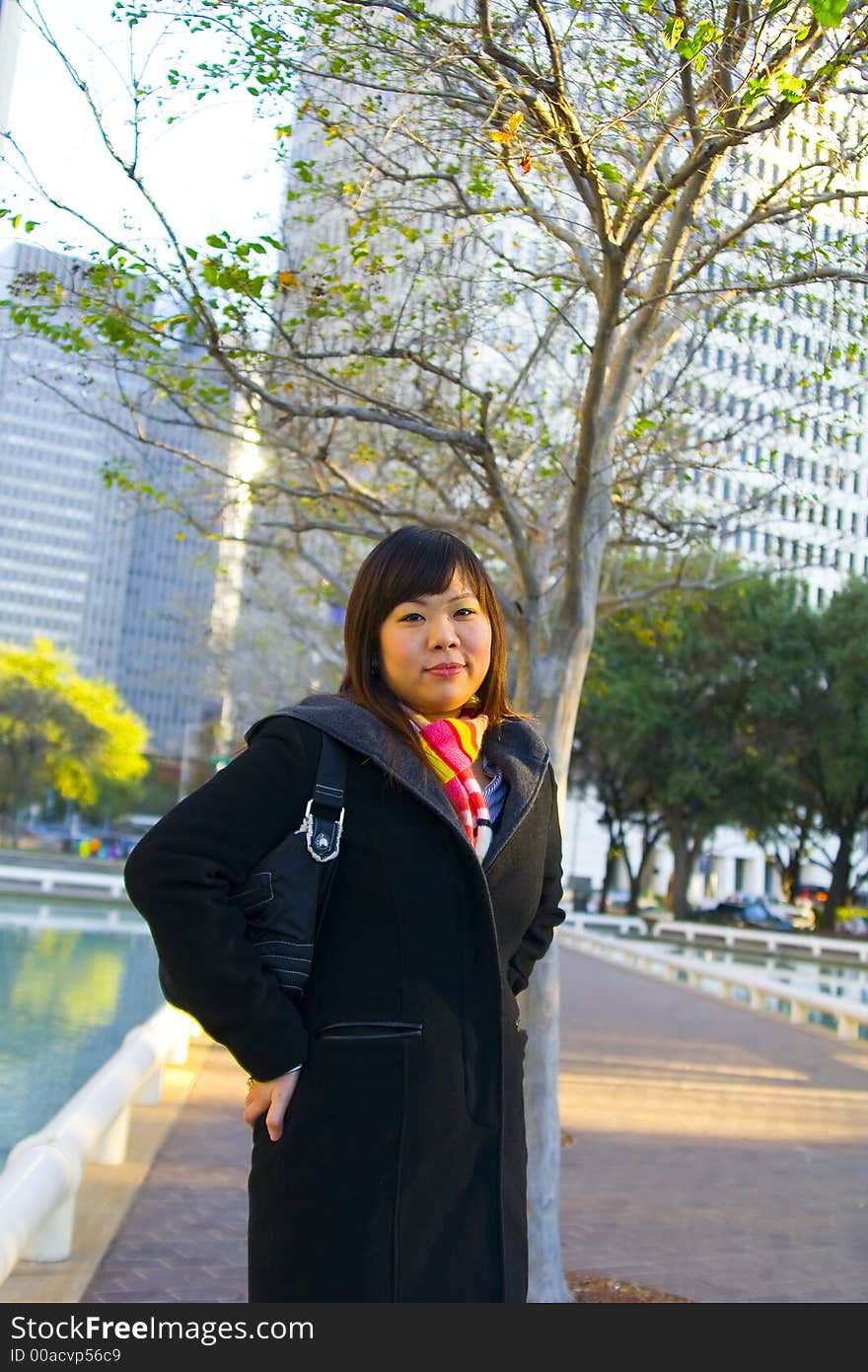 Young asian standing with city background. Young asian standing with city background