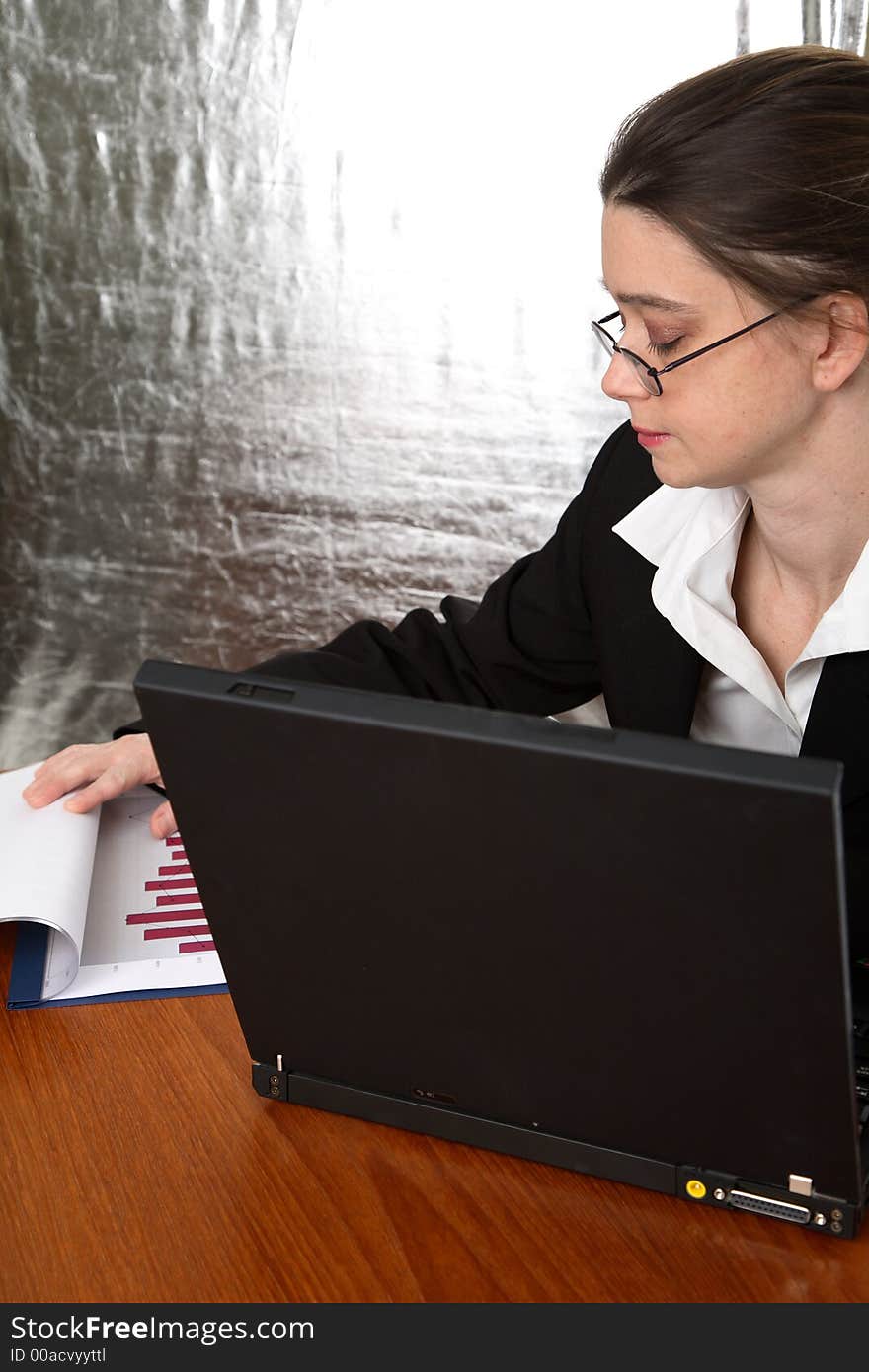 Young businesswoman reviewing the numbers. Young businesswoman reviewing the numbers