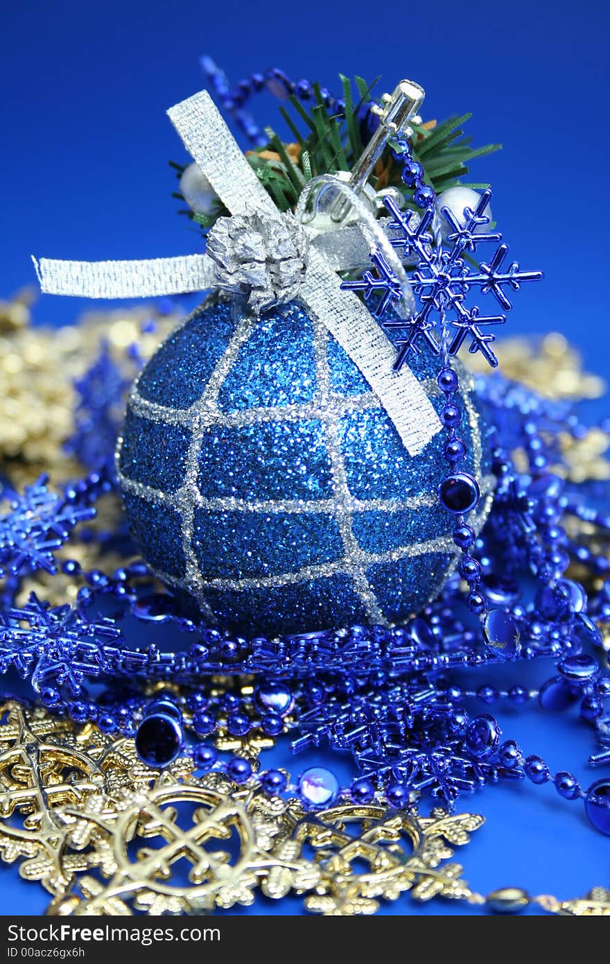 Christmas sphere of dark blue color with a pattern and a celebratory beads. Christmas sphere of dark blue color with a pattern and a celebratory beads