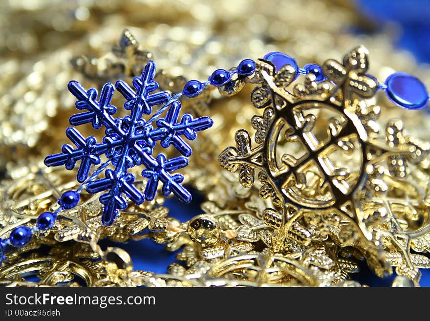 Christmas garlands of dark blue and yellow color in the form of snowflakes