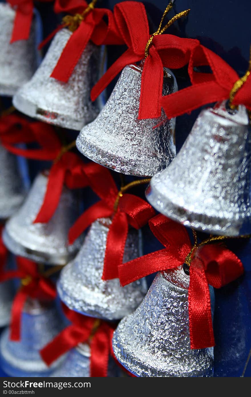 Christmas handbells of silvery color with red bows