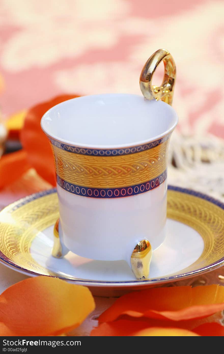 An empty tea cup, decorated with flowers