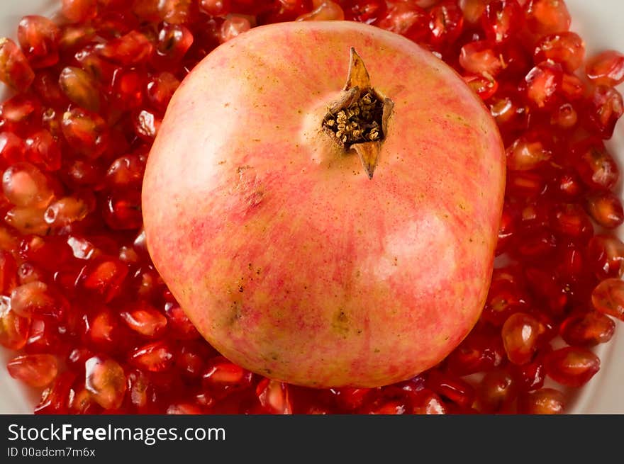 Pomegranate on red pomegranate grains. Pomegranate on red pomegranate grains