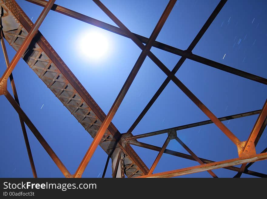 Moon rises over a metal frame. Moon rises over a metal frame