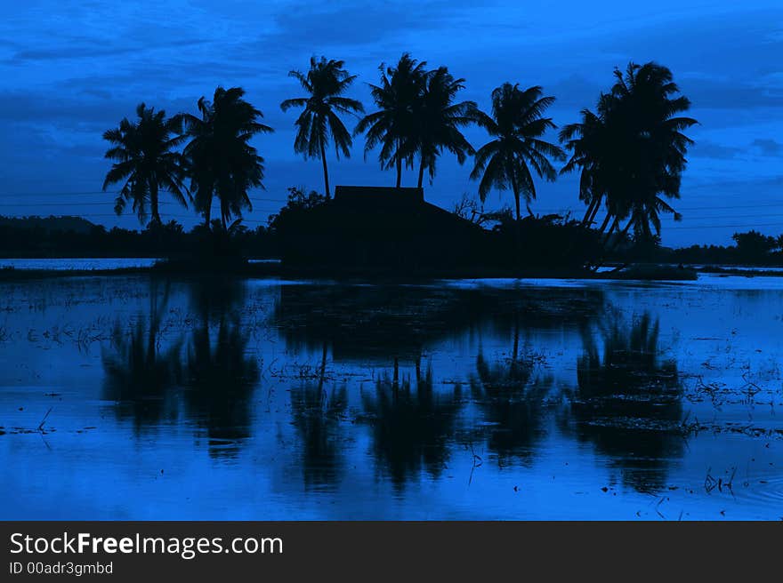 Traditional Malay village sunset view in silhouette. Traditional Malay village sunset view in silhouette.