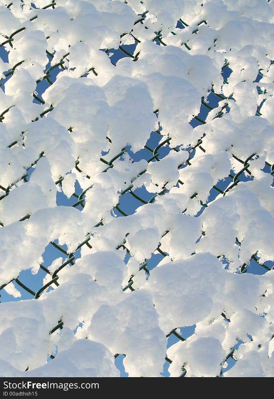 Chain link fence covered in snow. Chain link fence covered in snow.