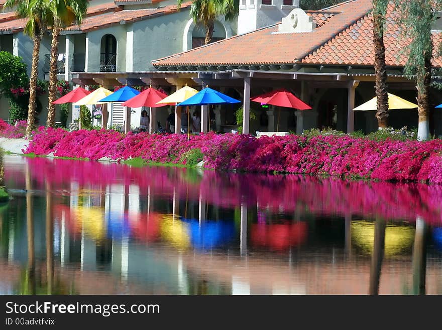 Colorful umbrellas reflect in lake water. Colorful umbrellas reflect in lake water