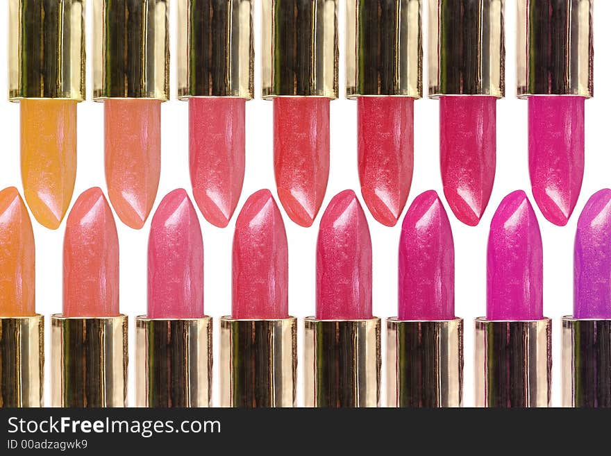 Overlaping rows of colorful lipsticks over white background. Overlaping rows of colorful lipsticks over white background