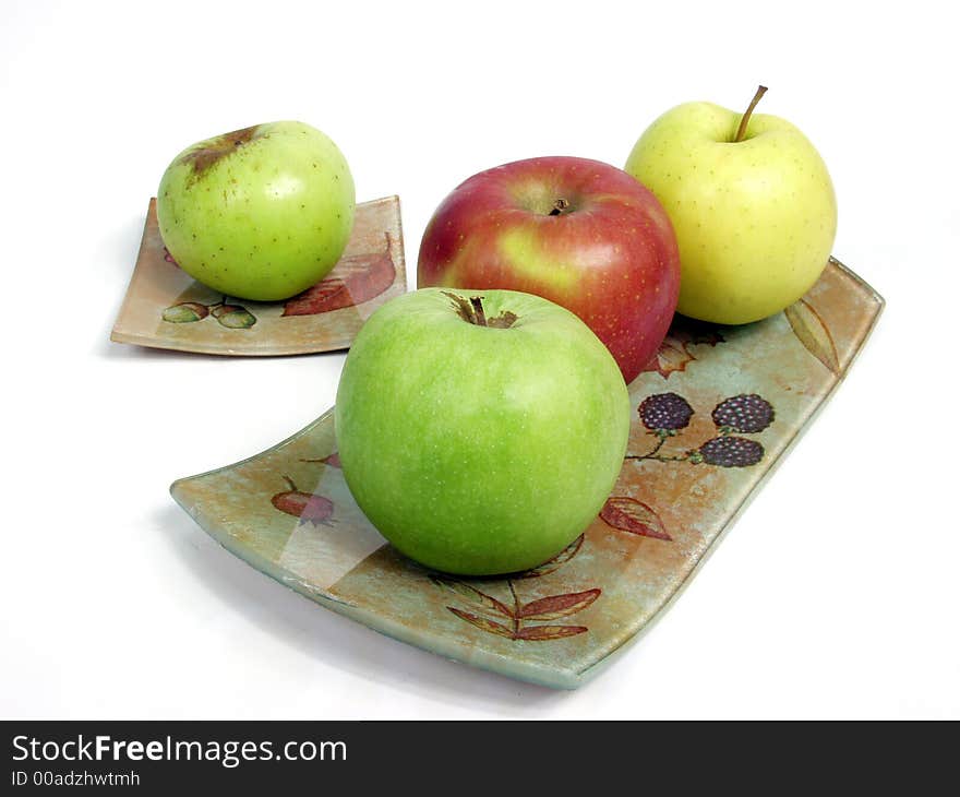 Decorated tray with red, geen and yellow apples.