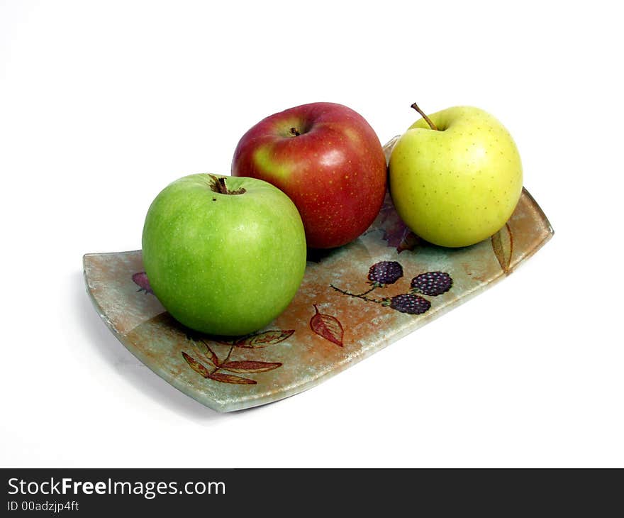 Decorated tray with red, geen and yellow apples.