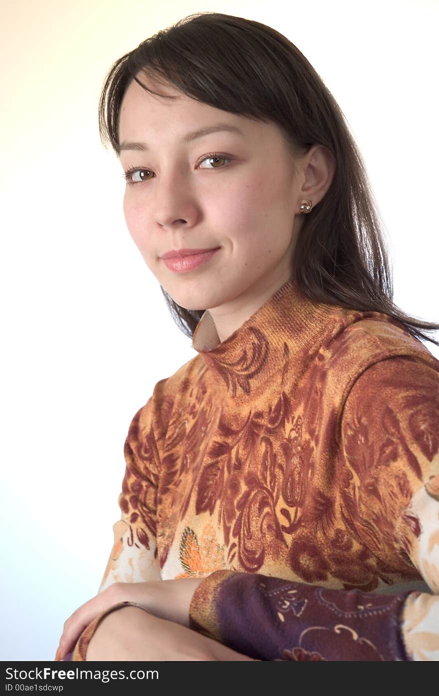 Young brunette shoulders portrait looking straight at the camera. Young brunette shoulders portrait looking straight at the camera