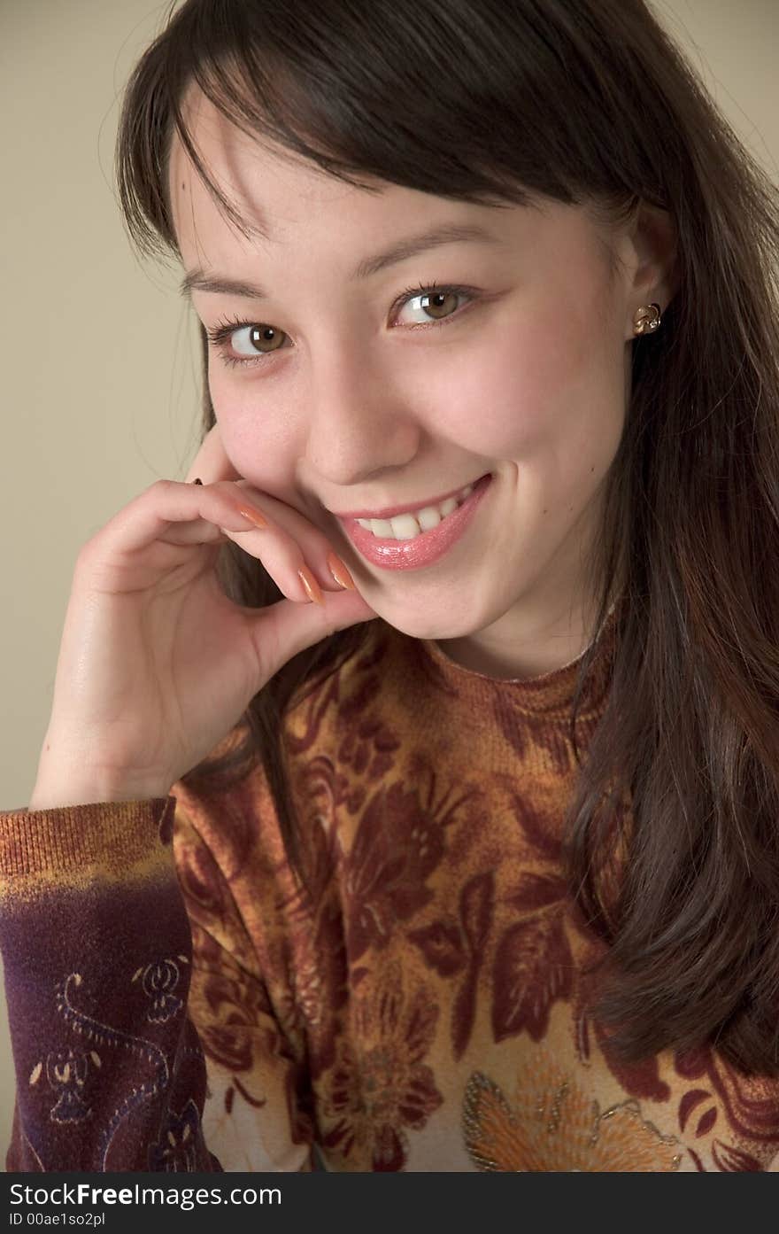 Young brunette shoulders portrait looking straight at the camera. Young brunette shoulders portrait looking straight at the camera