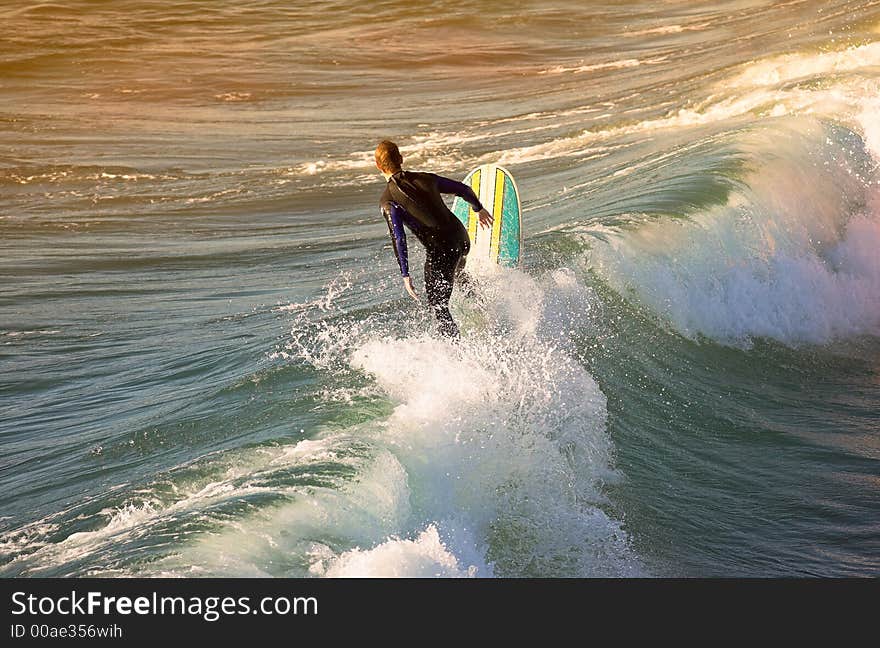 A photo of a surfer at sunset outside San Diego. A photo of a surfer at sunset outside San Diego