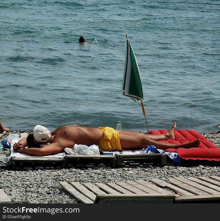 View of lying man on a beach.