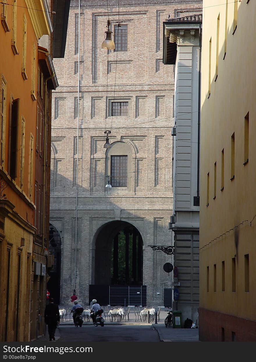 Monumental facade in Parma, with mopeds zooming past. Monumental facade in Parma, with mopeds zooming past