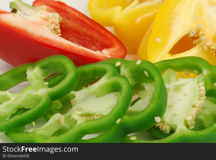 Sliced red, yellow and green sweet bell peppers. Sliced red, yellow and green sweet bell peppers.