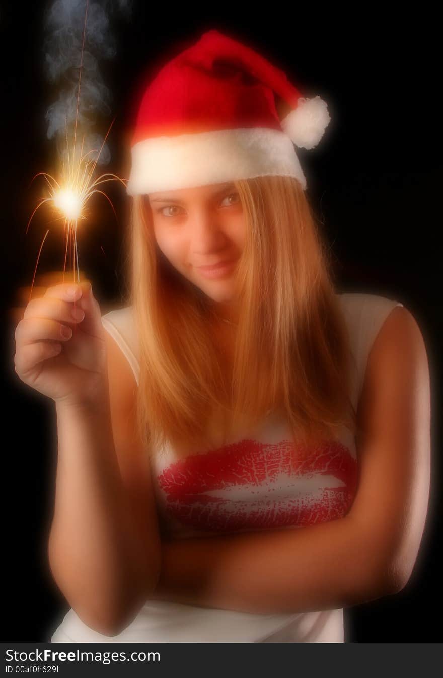 Christmas blonde girl with fireworks, black background, glow filter. Christmas blonde girl with fireworks, black background, glow filter