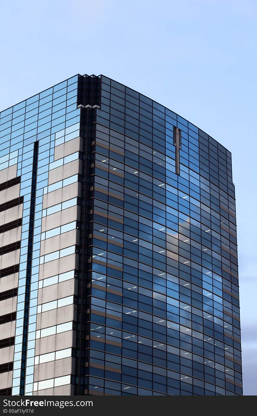 Image of an offices building with lights inside in the evening. Image of an offices building with lights inside in the evening.