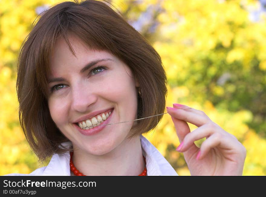 Girl with a strow in the autumn forest