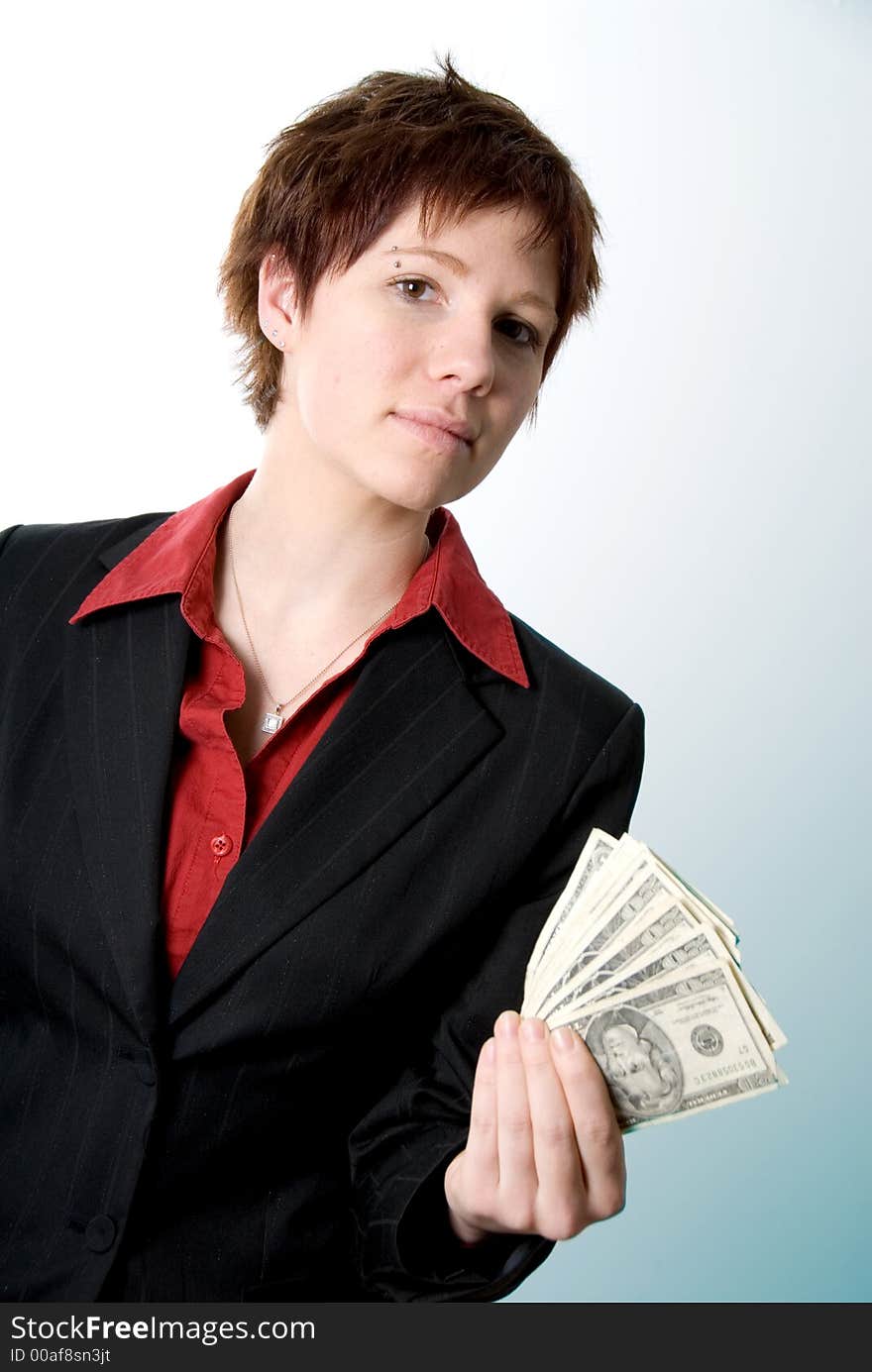 Serious woman in business attire holding some cash. Serious woman in business attire holding some cash