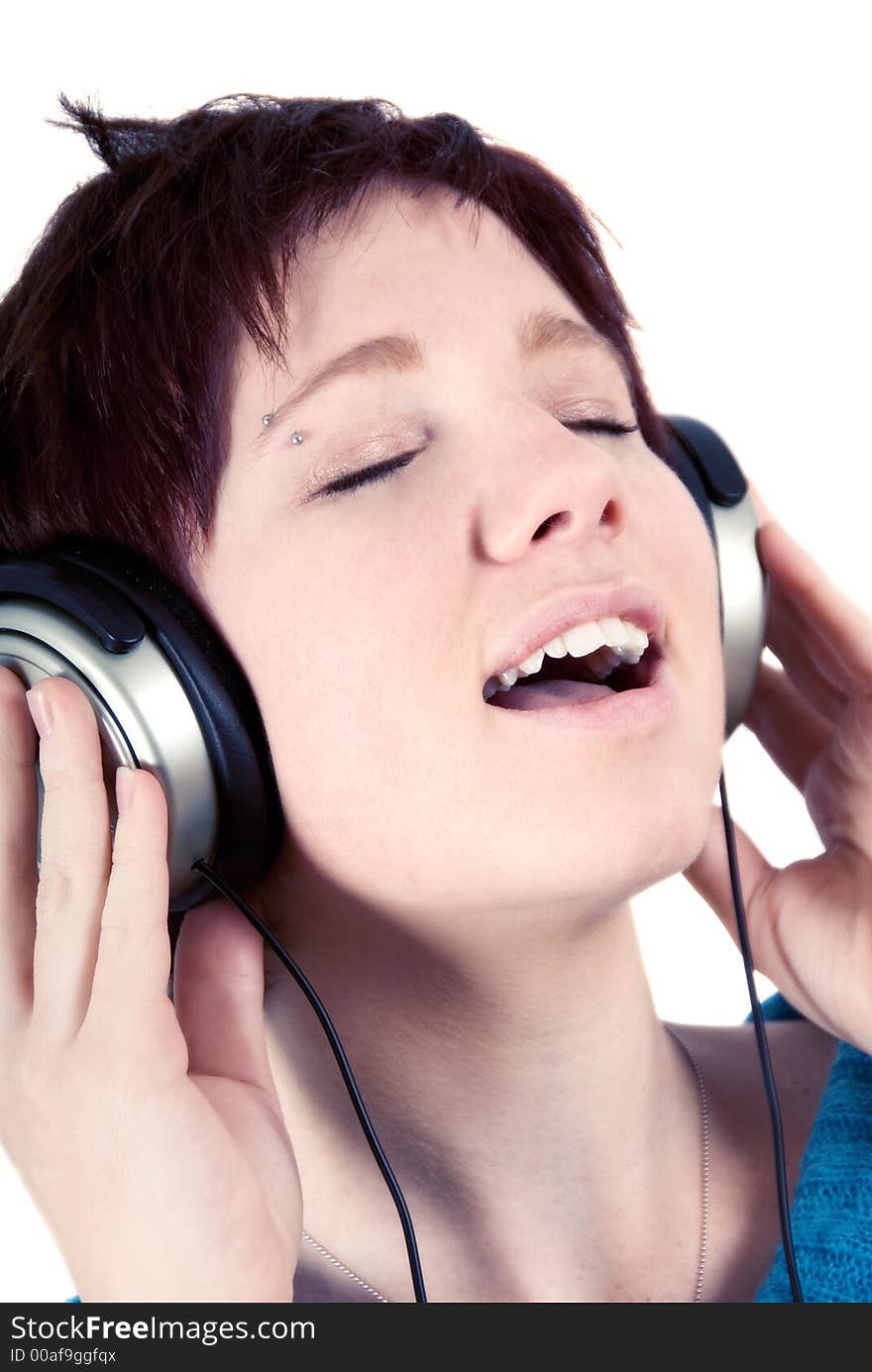 Woman holding headphones and singing. Woman holding headphones and singing